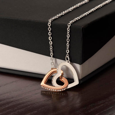 A delicate necklace with two interlocking hearts, symbolizing love and connection.