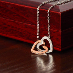 A delicate necklace with two interlocking hearts, symbolizing love and connection.